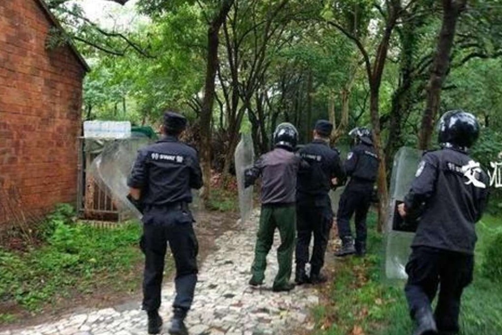 Police holding riot shields corner the bear before a sniper shoots it dead. Photo: SCMP Pictures