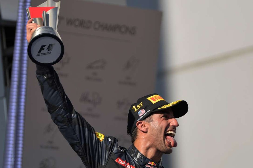 Daniel Ricciardo celebrates on the podium after winning during the Formula One Malaysian Grand Prix. Photo: AFP