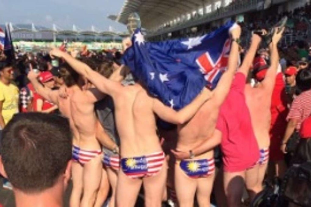 Photos of the men flaunting the country’s national colours went viral in Malaysia following the race. Photo: Twitter/Nik Asyraaf