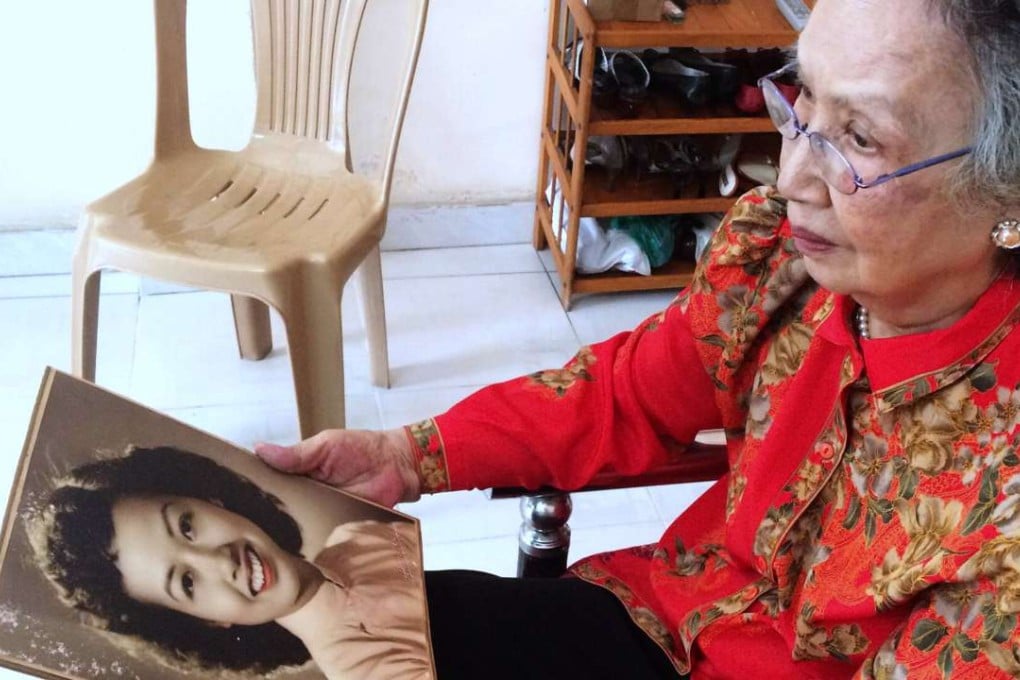 Trinh Thi Ngo, known as "Hanoi Hannah" for her propaganda broadcasts during the Vietnam War, holds a portrait of herself in her younger days while at her residence in Ho Chi Minh City in 2015. Photo: AFP