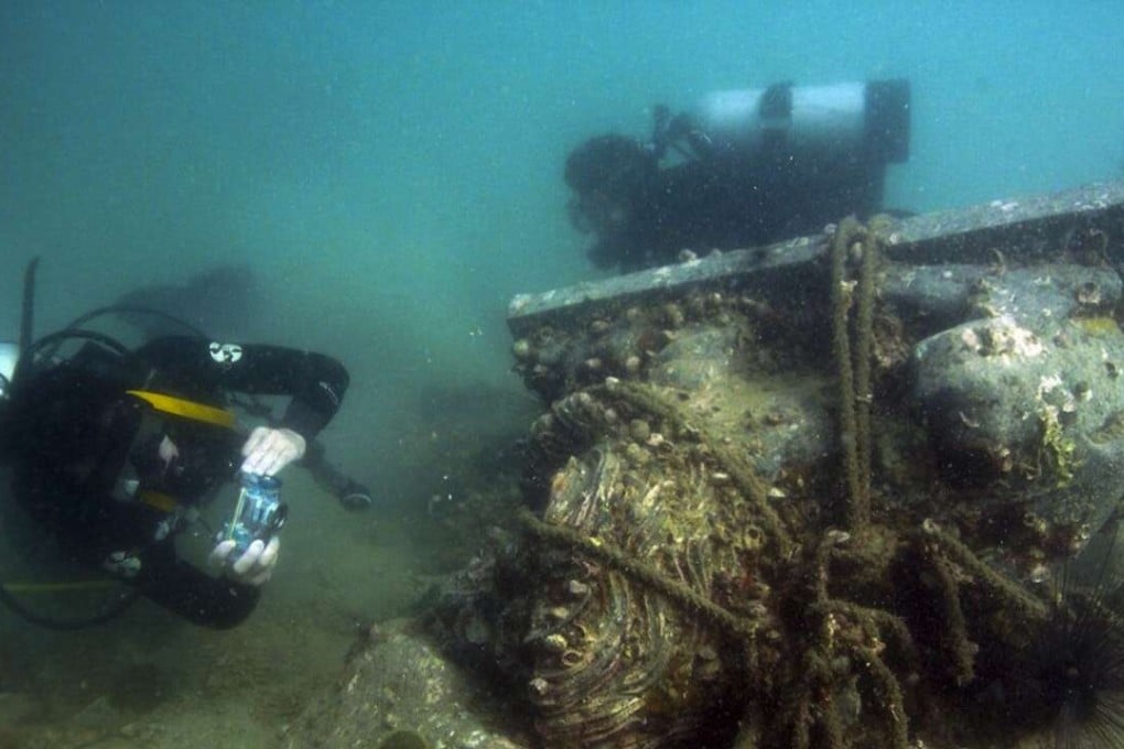 A local diver finds a Tin Hau stone lion in the waters of Tap Mun.
