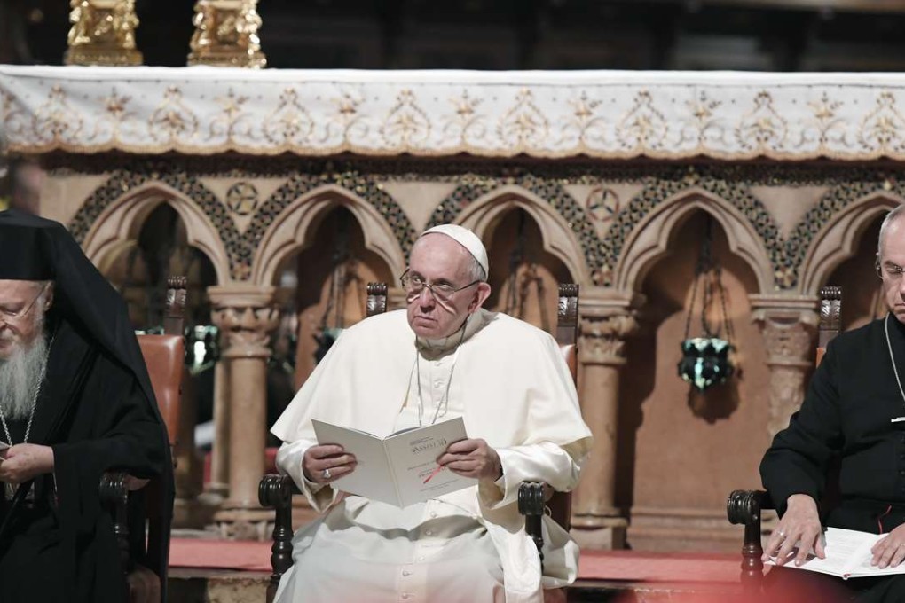 Pope Francis, center, flanked by Orthodox Patriarch of Constantinople Bartholomew I, left, and Canterbury Archbishop Justin Welby, pray together inside the Basilica of St. Francis, in Assisi. Photo: AP