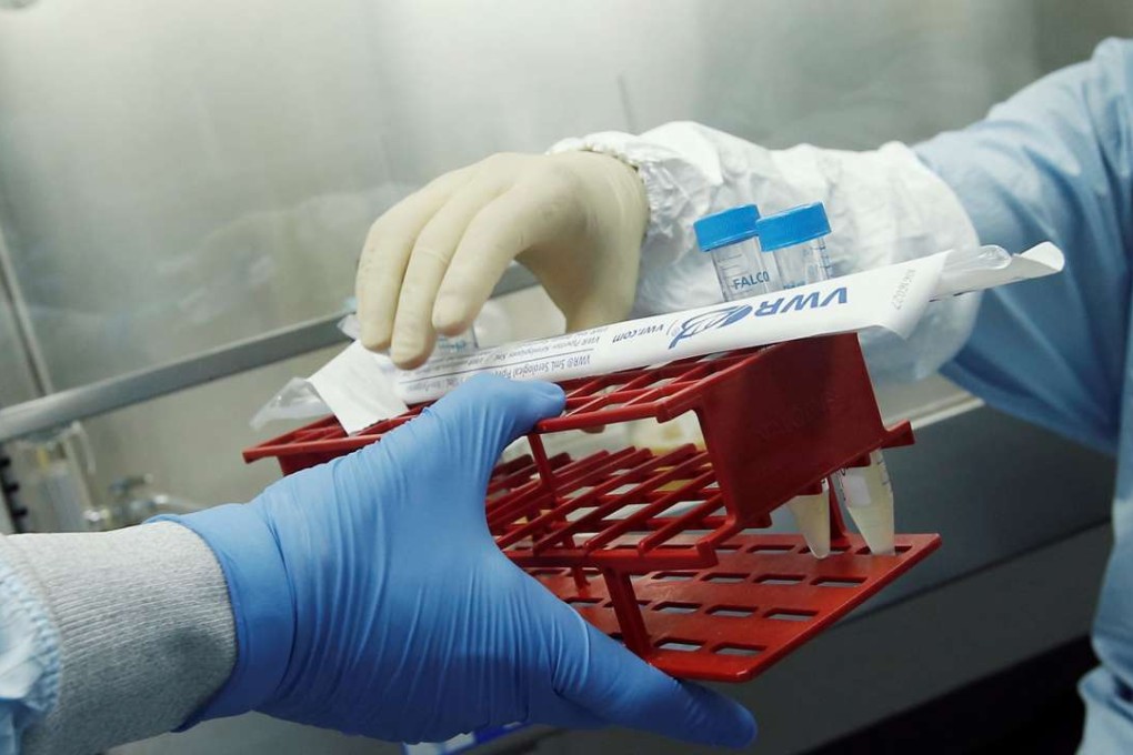 Manufacturing Associates Theodore Szmurlo (L) and David Artus work in a cell culture room where they are working on developing a vaccine for the Zika virus. Photo: Reuters