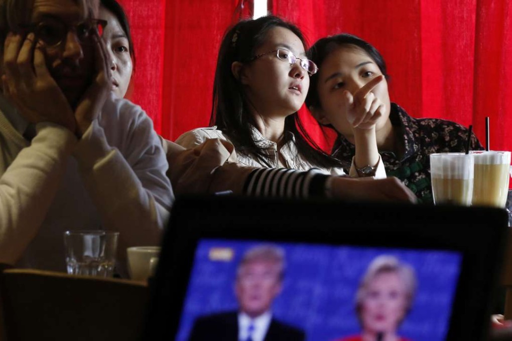 Chinese students chat as they watch a live broadcast of the presidential debate between Democratic presidential candidate Hillary Clinton and Republican presidential candidate Donald Trump, at a cafe in Beijing last month. Photo: AP
