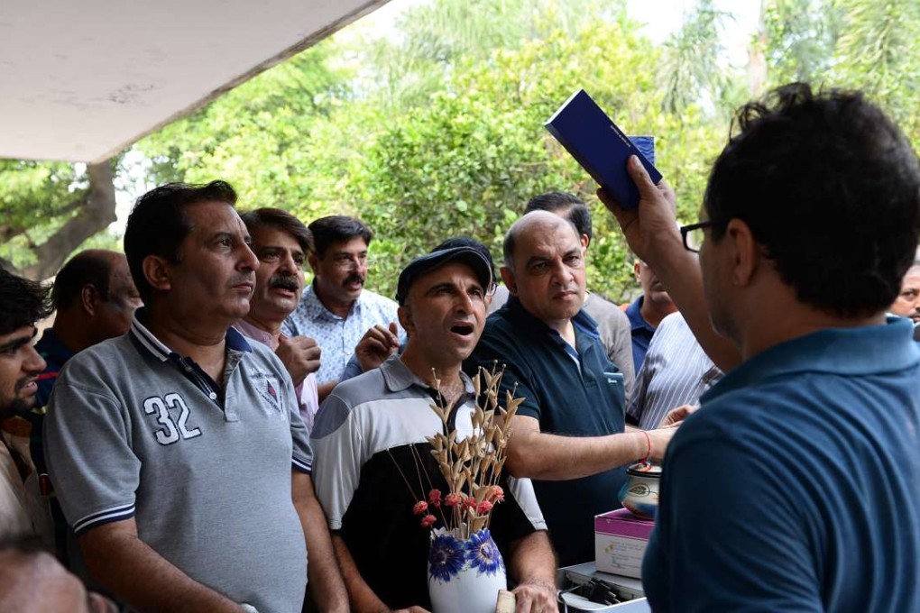 Indian participants bid for items at an auction in New Delhi. Photo: AFP