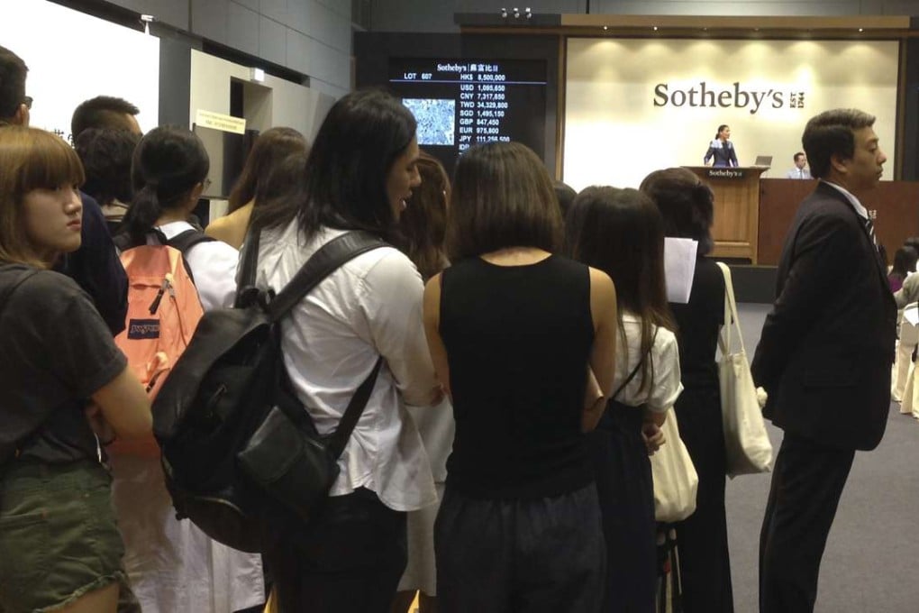Fans of T.O.P. were allowed to watch the Sotheby’s auction co-curated by the K-pop star, having initially been denied entry to the sale room. Photo: Enid Tsui