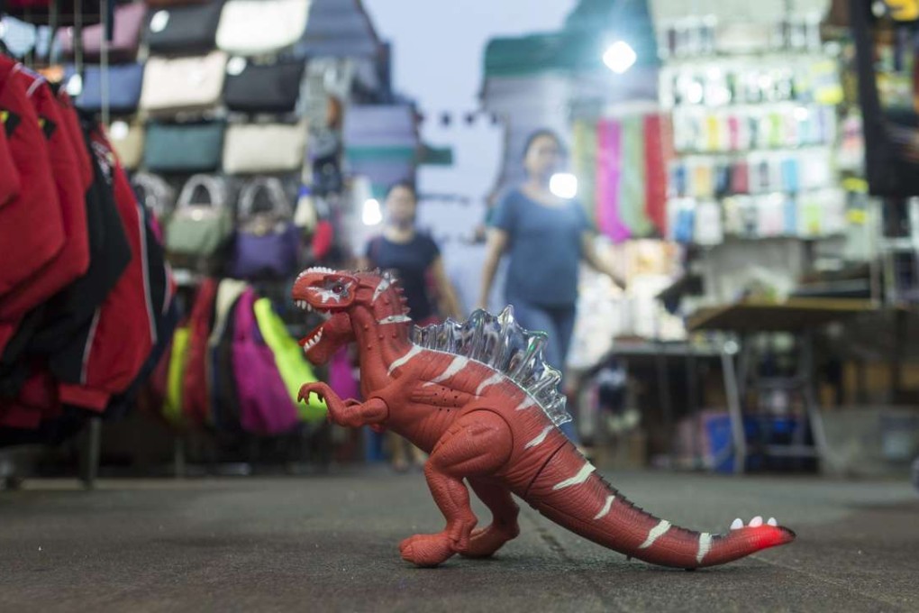 A toy dinosaur for sale at Hong Kong’s Temple Street night market. When Hong Kong’s economic growth hits a wall, the government must lead to invest in our future. Photo: EPA