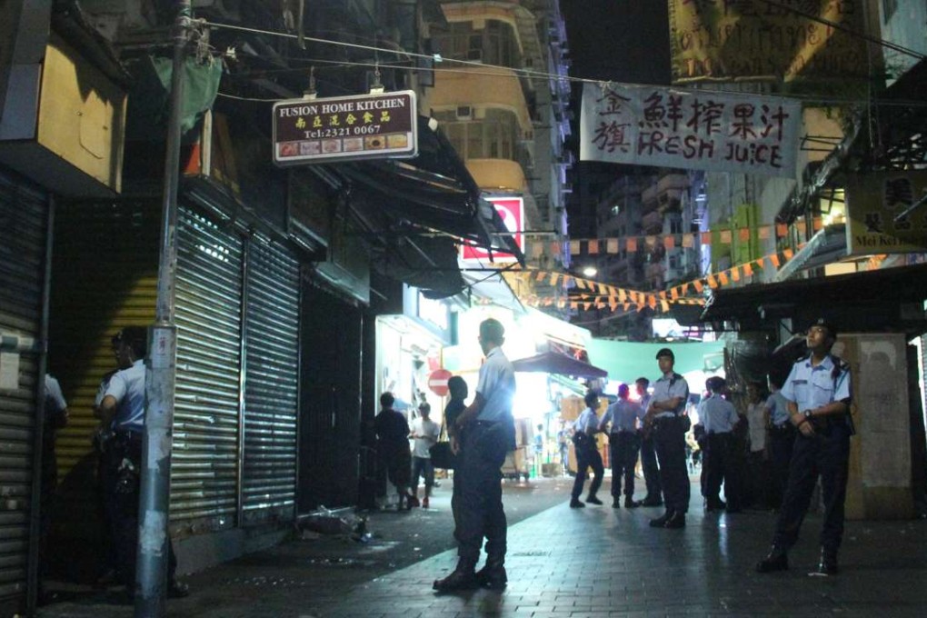 Police hunt for suspects in the Yau Ma Tei neighbourhood where they opened fire. Photo: SCMP Pictures