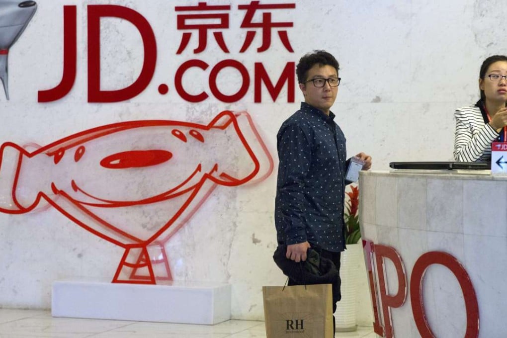 Visitors wait at the entrance to JD.com head office in Beijing. JD.com has grown into Chinas biggest Internet-based direct retailer. Photo: AP