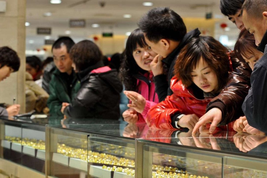 Gold draws the crowds at a shopping mall in Beijing in February 2011. China’s economy has enjoyed the effects of three generations’ savings being released at once. Photo: Xinhua