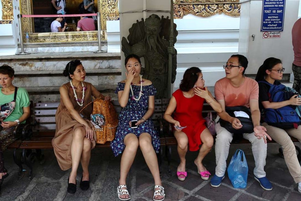 Chinese tourists take a break at Wat Pho in Bangkok. Photo: Reuters