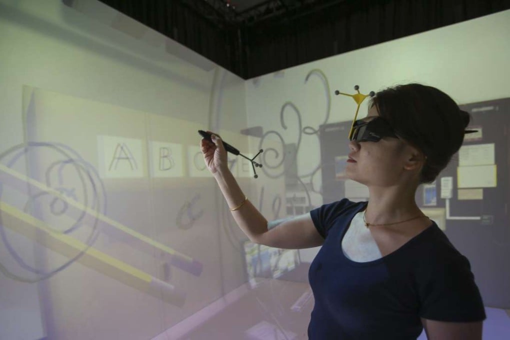 Hong Kong University Virtual Reality team member Aki Dai demonstrates how to use a MagicPad. Photo: Chen Xiaomei