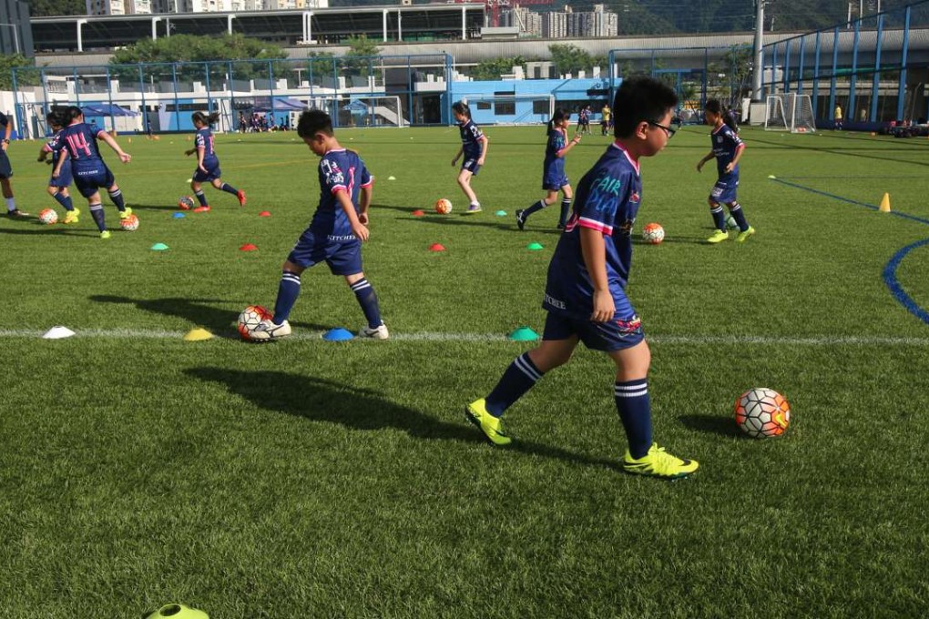 Children play football at Jockey Club Kitchee Centre in Shek Mun. Photo: David Wong
