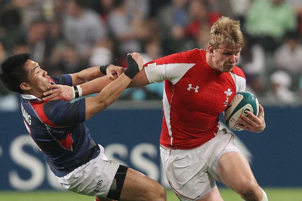 Gareth Baber’s new assistant Jevon Groves is tackled by Hong Kong’s Tsang Hing-hung while playing for Wales at the 2011 Hong Kong Sevens. Photos: HKRU