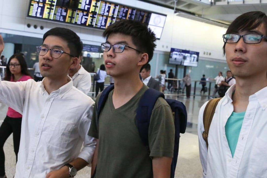 Joshua Wong (centre) arrives at Hong Kong International after being denied entry into Thailand. Photo: Sam Tsang