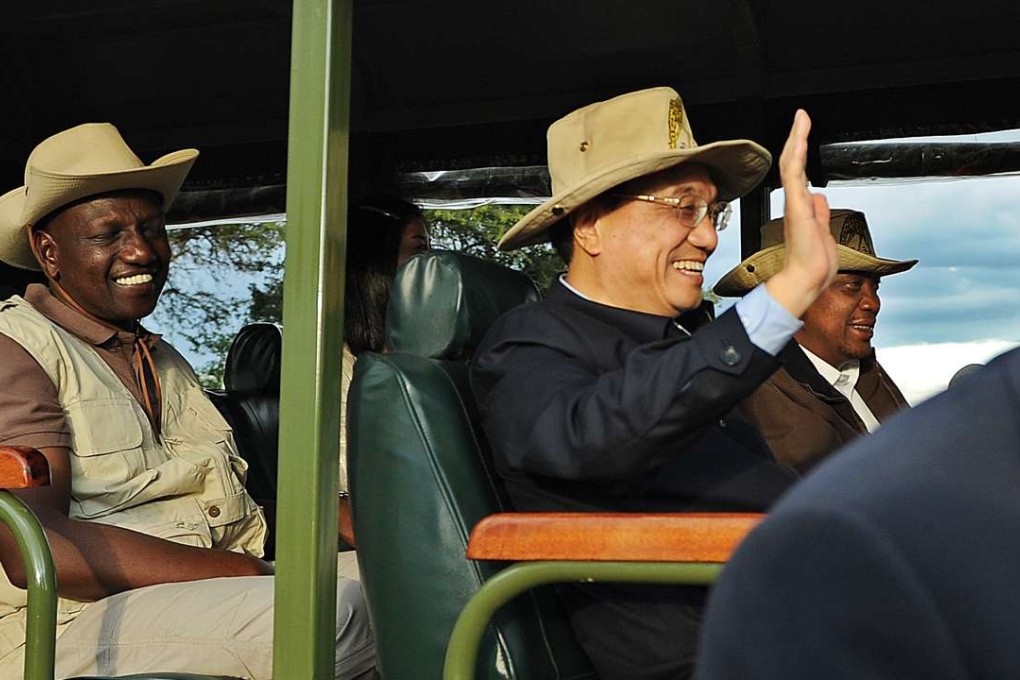 Chinese Prime Minister Li Keqiang rides in a customised game-viewing vehicle with Kenyan President, Uhuru Kenyatta, right, and his vice-President, William Ruto in May 2014 at the Nairobi national park. Kenya secured a loan to build the SGR line during the visit. Photo: AFP