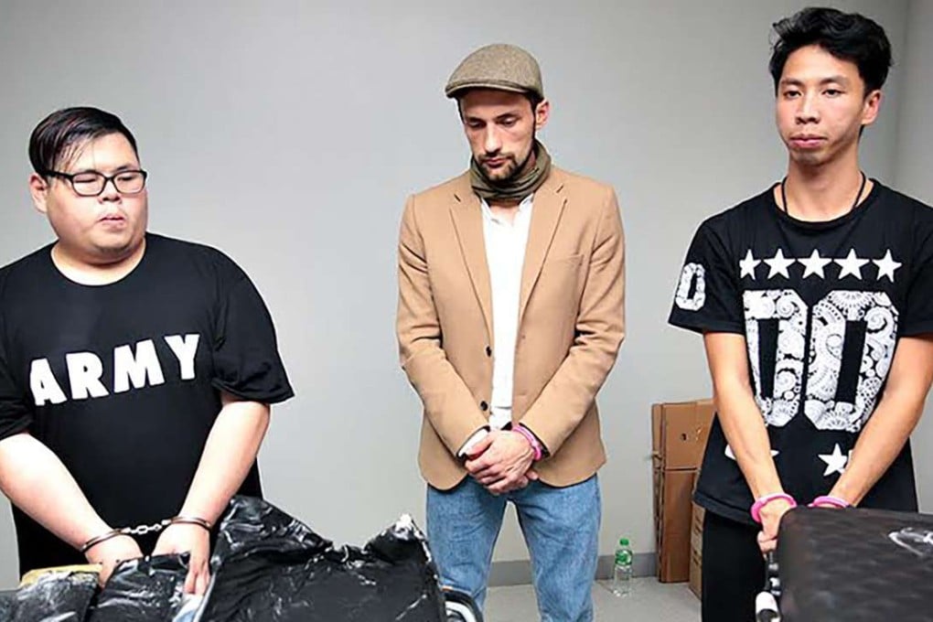 Hong Kong nationals Chan Ka-wai (left) and Evan Pau Ho-man (right) were arrested at Ninoy Aquino International Airport, along with Russian national Yuri Kirdyushkin (centre) on Wednesday. Photo: Manila International Airport Authority