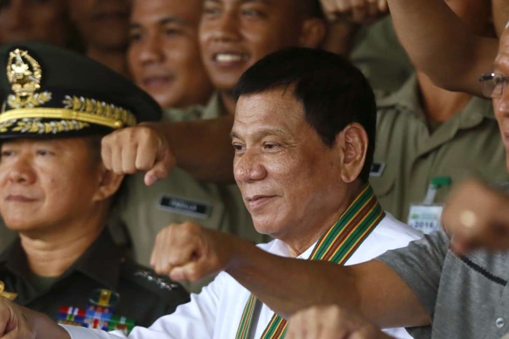 From left, Philippine Army chief Eduardo Ano, Philippine President Rodrigo Duterte, and National Defence chief Delfin Lorenzana, gesture with a fist bump as they pose with Philippine Army officers. Photo: AP