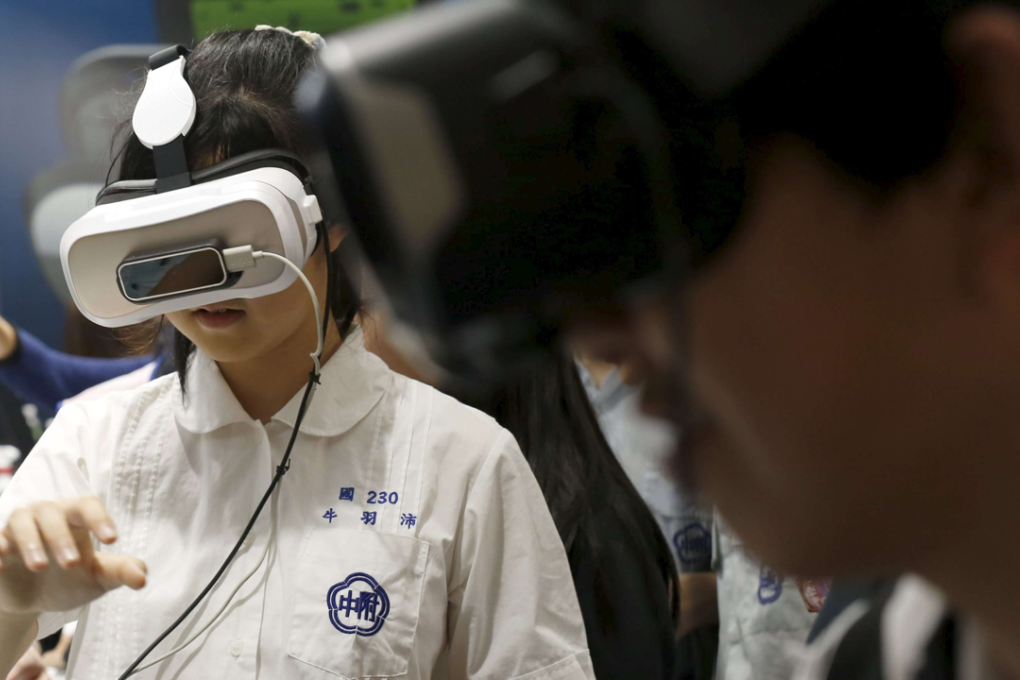 Visitors try 3Glasses D2 Vanguard by China's Virtual Reality Technology during the Spring Computer show in Taipei. Photo: Reuters