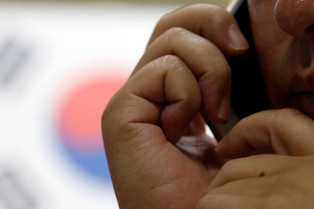 A North Korean defector on his phone during an interview. Photo: Reuters