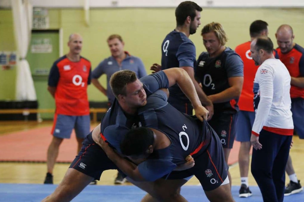 England's Teimana Harrison and Mako Vunipola grapple during the judo session that has seen Eddie Jones come under fire. Photos: Reuters