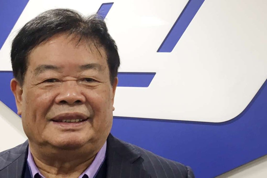 Cho Tak Wong, 70-year-old chairman of Fuyao Glass, a Chinese-based leading supplier of automotive glass worldwide, poses in front of the corporate logo at the primary Fuyao Glass production plant in the United States. Photo: Reuters