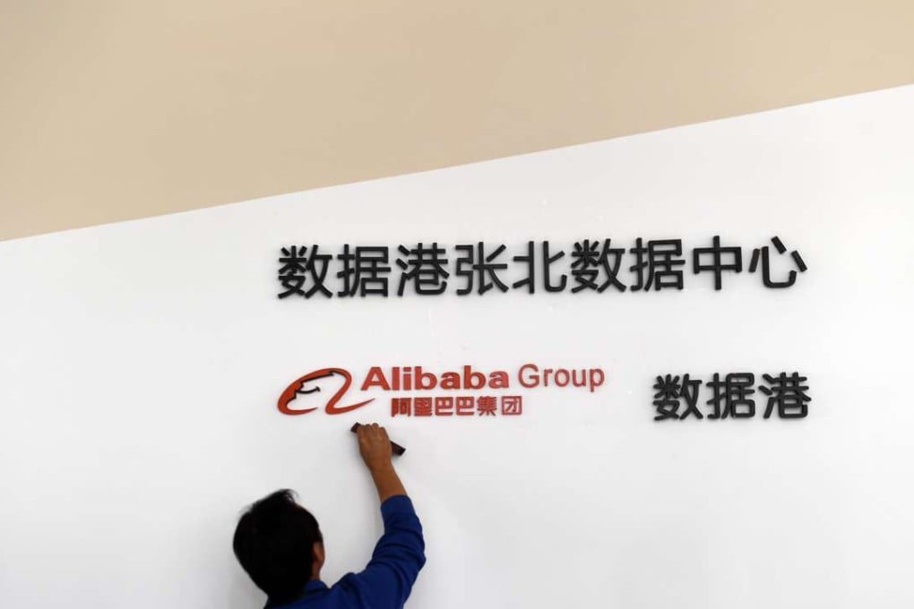 A staff member cleans the corporate logo at Alibaba's data centre in Zhangbei, Hebei province in September. Photo: Xinhua