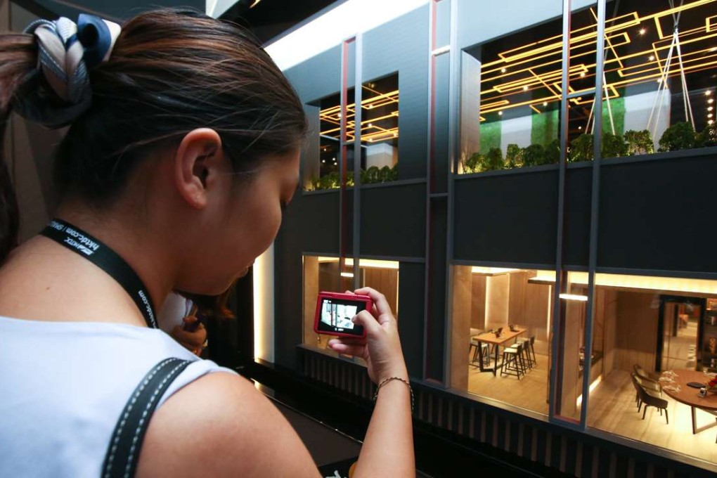 A woman checks flat models for Henderson Land’s Park One development in Sham Shui Po. Photo: Edward Wong