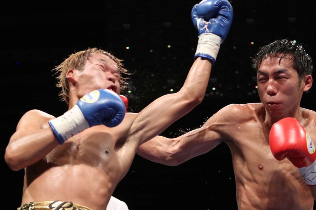 Japan’s Ryuto Maekawa misses with a left as Rex Tso connects with a right during their bout in "Battle of Victors" at the Hong Kong Convention and Exhibition Centre. Photo: Edward Wong