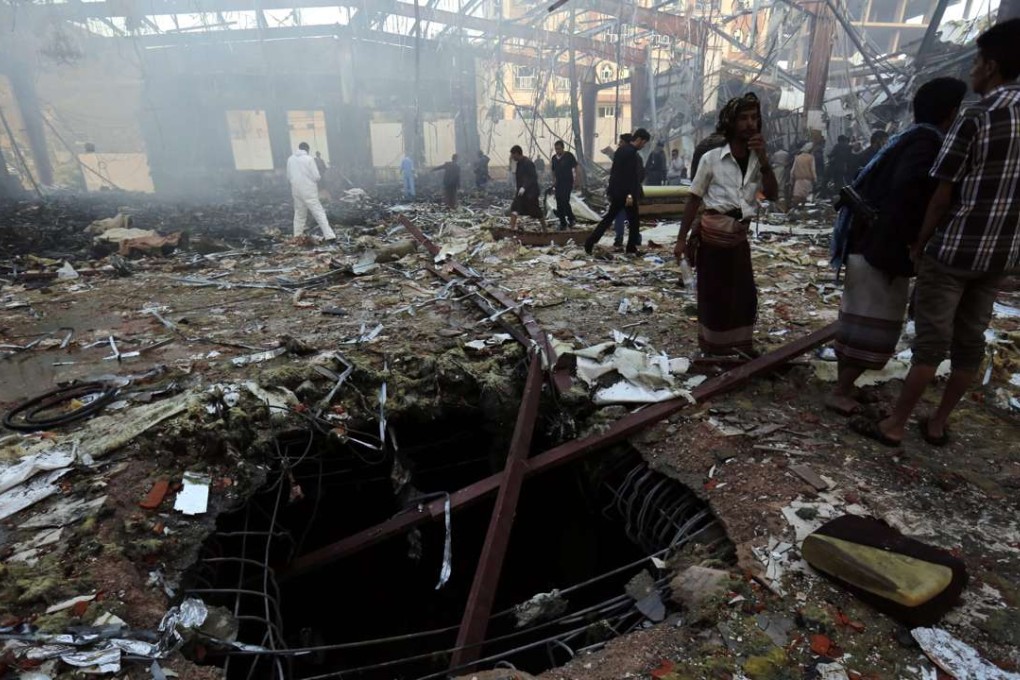 Yemenis inspect the site of Saudi-led airstrikes that hit a funeral ceremony in Sanaa, Yemen. Photo: EPA