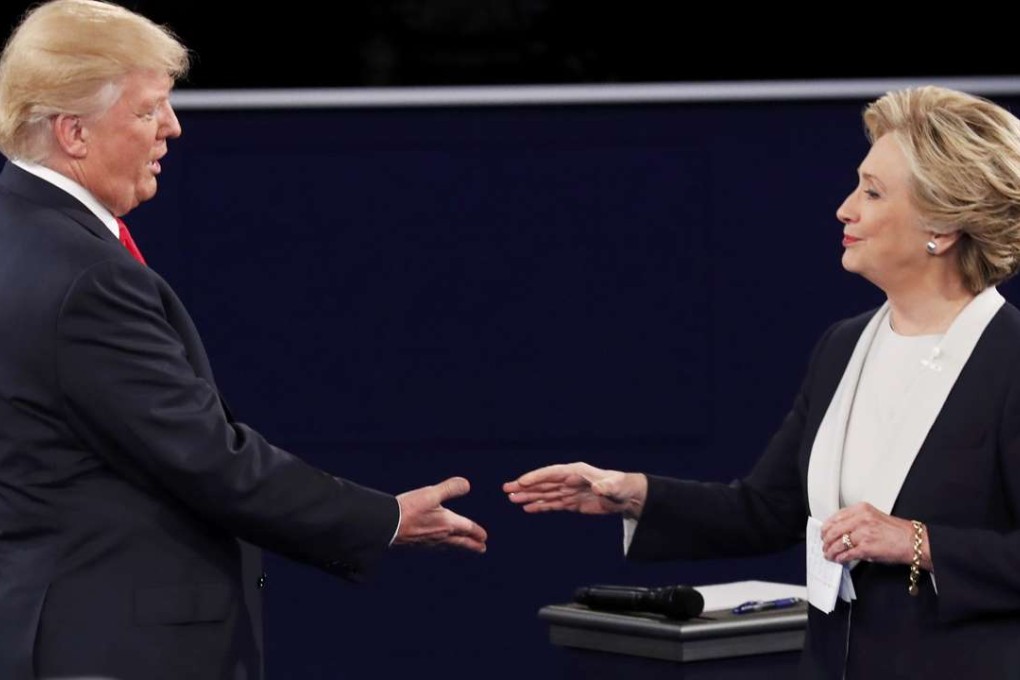 Republican nominee Donald Trump and Democratic nominee Hillary Clinton close the second US presidential debate with a handshake. Photo: Reuters
