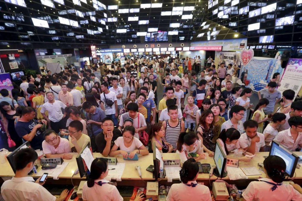 People wait for tickets at a ticket office of a movie theatre in Wuhan, Hubei province. Box office receipts were down over the National Day holiday. Photo: Reuters