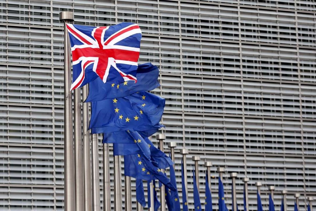 A British flag flutters next to European Union flags at the EU Commission headquarters in Brussels. Photo: Reuters