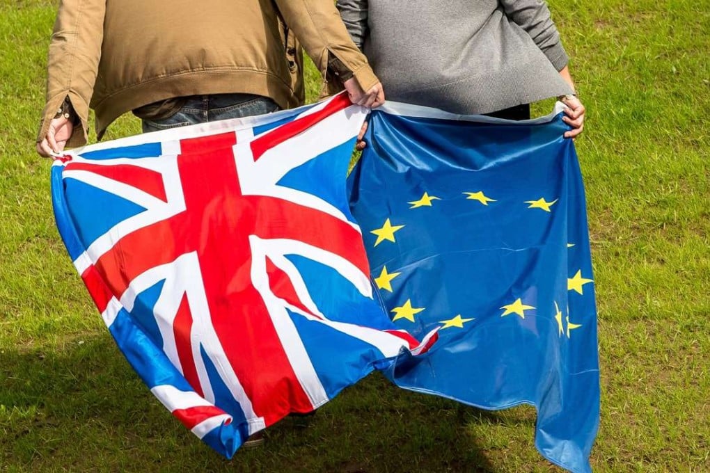 People display United Kingdom and Europe's flags in Neufchâtel-Hardelot. Photo: AFP
