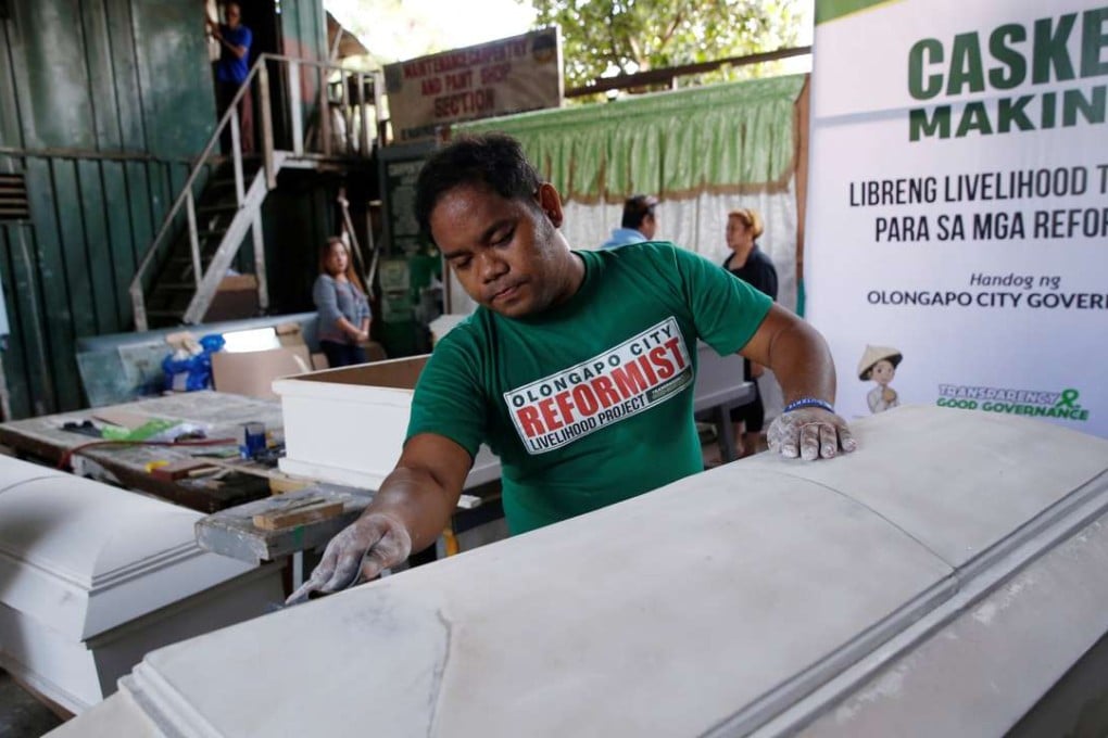 A former drug user undergoing rehabilitation makes coffins. Photo: Reuters
