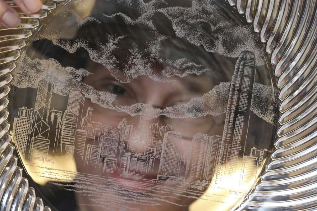 Dominic Fondé with his engraved plate, which shows the skyline of Hong Kong and Victoria Harbour. Photo: K.Y. Cheng