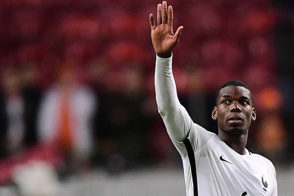 France's midfielder Paul Pogba celebrates his team's victory at the end of the FIFA World Cup 2018 qualifying football match Netherlands vs France on October 10, 2016 at the Amsterdam Arena in Amsterdam. / AFP PHOTO / EMMANUEL DUNAND