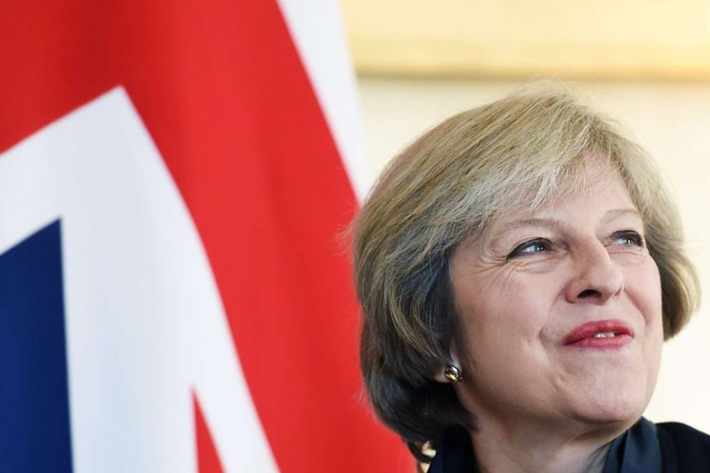British Prime Minister Theresa May smiles after a meeting at 10 Downing Street in London. Photo: EPA