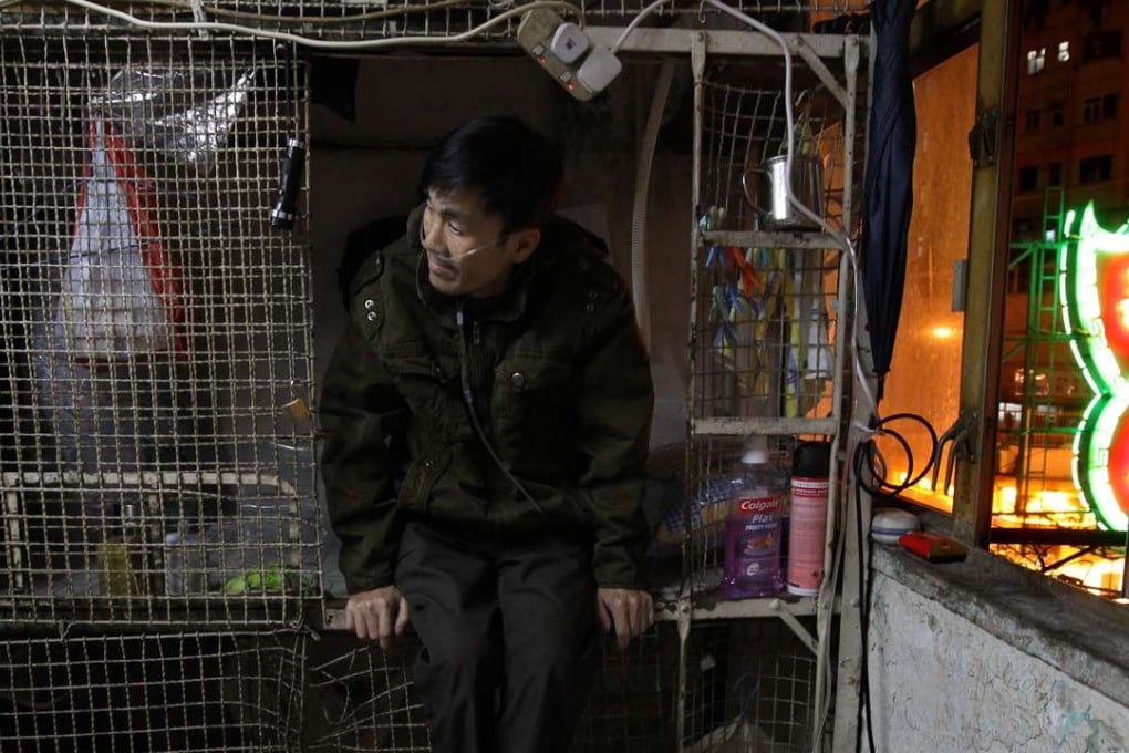 Tang Man-wai, 64 sits in his cage home in Mongkok. Photo: Dickson Lee