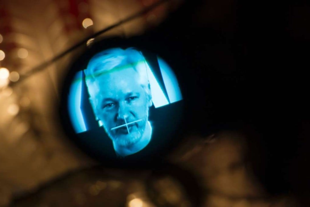 Julian Assange, founder of WikiLeaks, is seen through the eyepiece of a camera as he is displayed on a screen via a live video connection during a press conference on the platform's 10th anniversary last week in Berlin. Photo: AFP