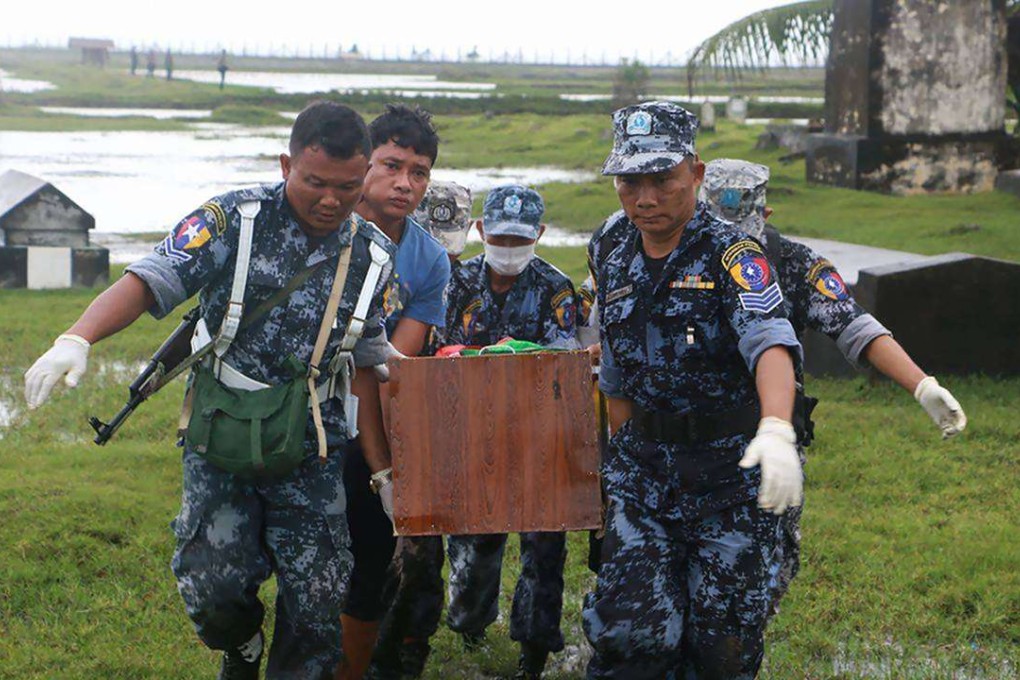Myanmar border police carry a coffin draped with a Myanmar flag bearing a body of one of the nine border guards killed in mysterious raids. Photo: AFP