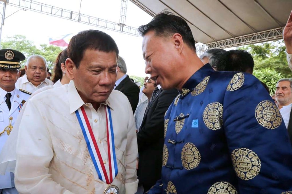 ‘The clouds are fading away’: President Rodrigo Duterte shakes hands with Chinese Ambassador to the Philippines Zhao Jianhua. Photo: EPA