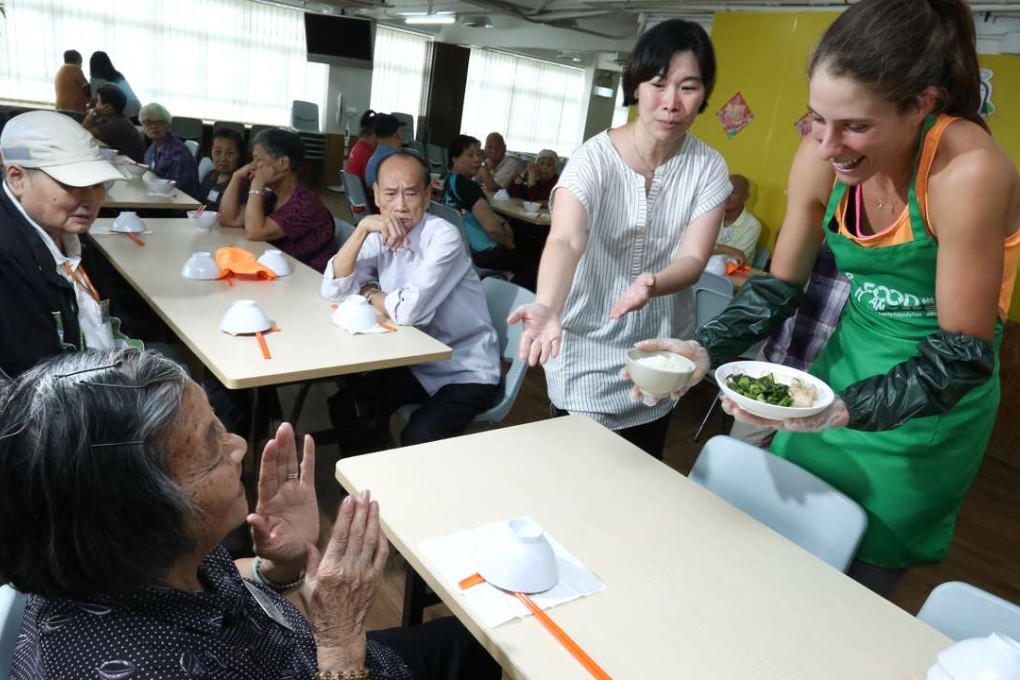 Briton Johanna Konta serves an elderly person in Sham Shui Po. Photo: Jonathan Wong