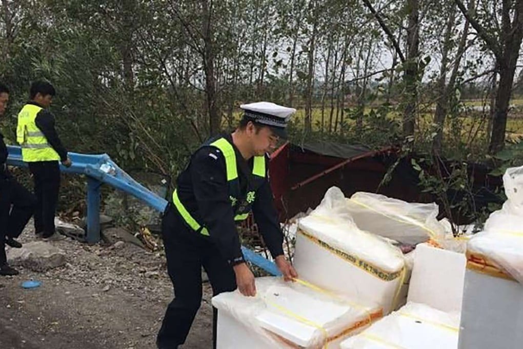Police officers help with the clean-up after the accident on the highway in Jinzhou, Hubei province. Photo: SCMP Pictures