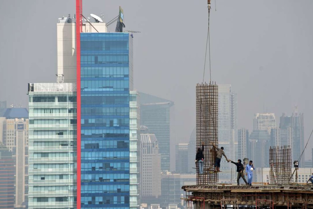 Jakarta is expanding upwards – but what is life like for those who are building it? Photo: AFP