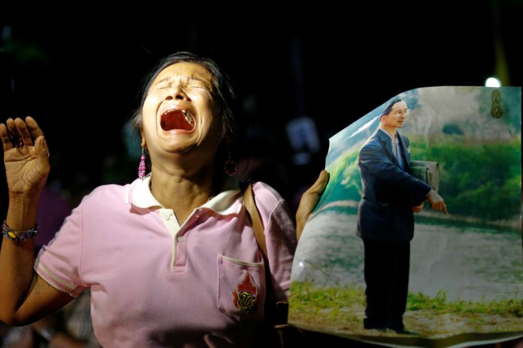 A woman weeps after an announcement that Thailand's King Bhumibol Adulyadej has died. Photo: Reuters