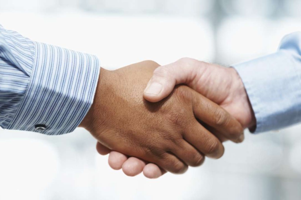 *One time use only* Business deal - Closeup of a handshake against blur background