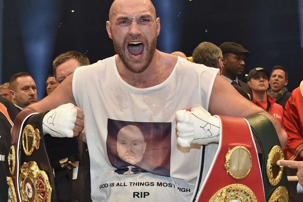 FILE - In this Nov. 29, 2015 file photo, Britain's new world champion Tyson Fury, celebrates with the WBA, IBF, WBO and IBO belts after winning the world heavyweight title fight against Ukraine's Wladimir Klitschko in Duesseldorf, western Germany. Fury has vacated his WBO and WBA world titles to concentrate on his treatment and recovery from drug use and other personal issues. Fury’s promotors released a statement early Thursday, Oct. 13, 2016, confirming the decision. It comes in the wake of his second withdrawal from a rematch with Wladimir Klitschko after being declared "medically unfit" and following his admitted bingeing on cocaine and alcohol. (AP Photo/Martin Meissner, File)