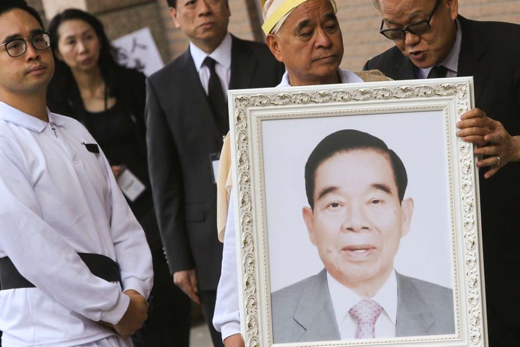 Henry Cheng Kar-shun, son of Cheng Yu-tung, holds his father's photo during the funeral at Cape Collinson Crematorium on Thursday. Photo: Sam Tsang