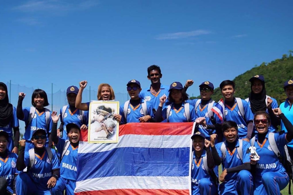 Thailand's women players hold up a picture of their king after beating Nepal in the ICC World Cup Asia qualifiers.